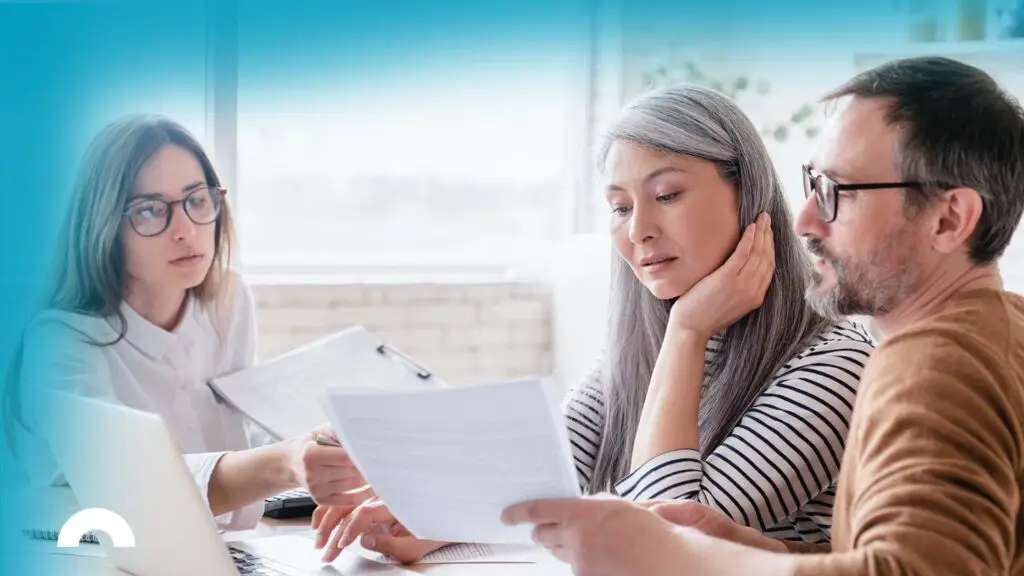 financial advisor reviewing bankruptcy options with middle aged couple