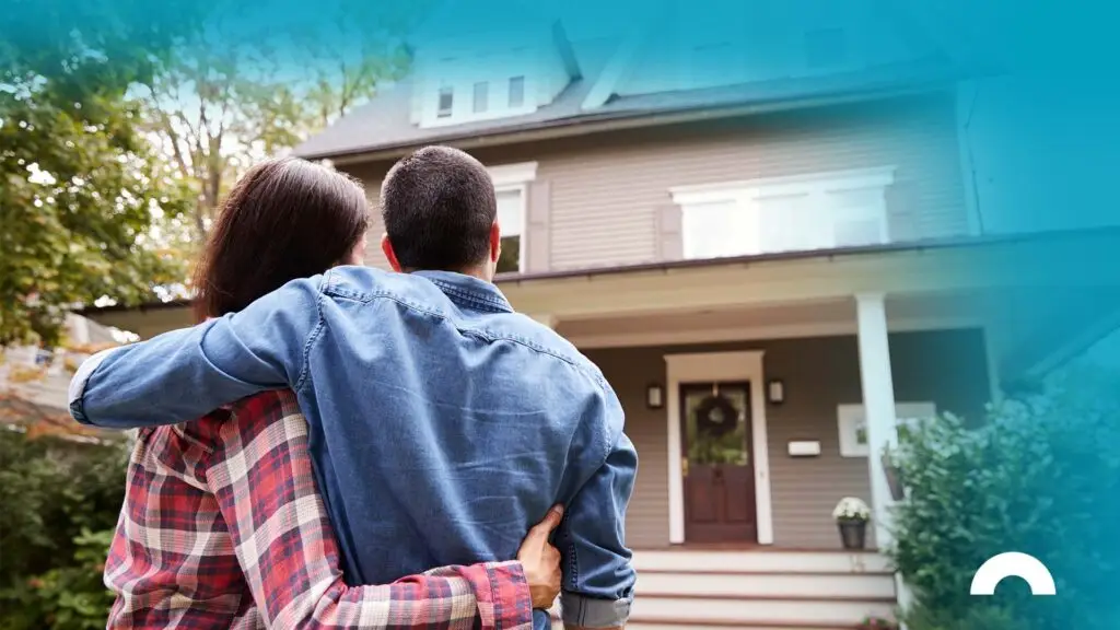 young couple looks at their house