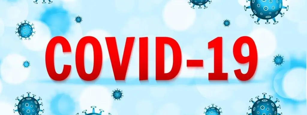 covid-19 red text in the middle of illustrations of the virus on a blue background